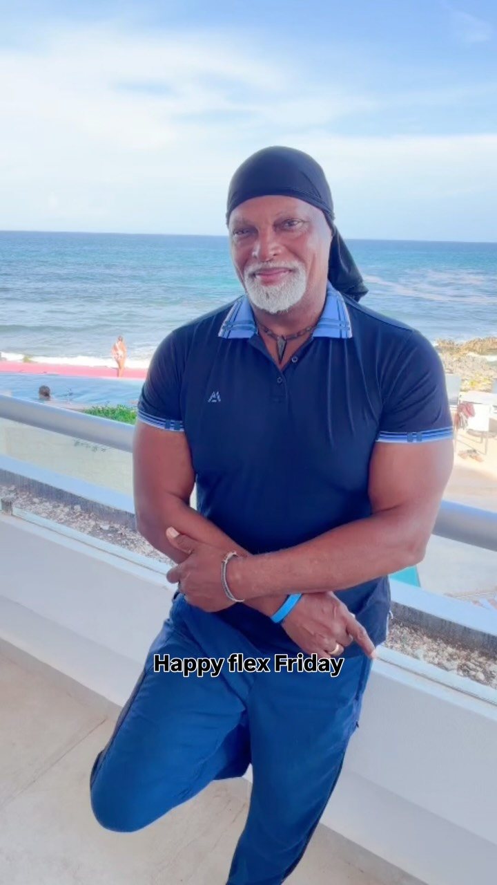 Rafael in tree pose on a terrace above the ocean in Costa Rica